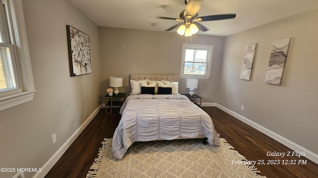 bedroom with dark wood-type flooring, ceiling fan, and baseboards