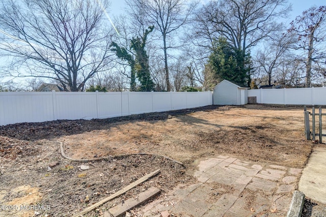 view of yard featuring a fenced backyard and a storage shed