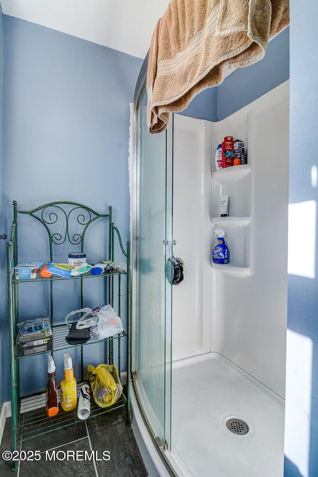 bathroom with a shower with door