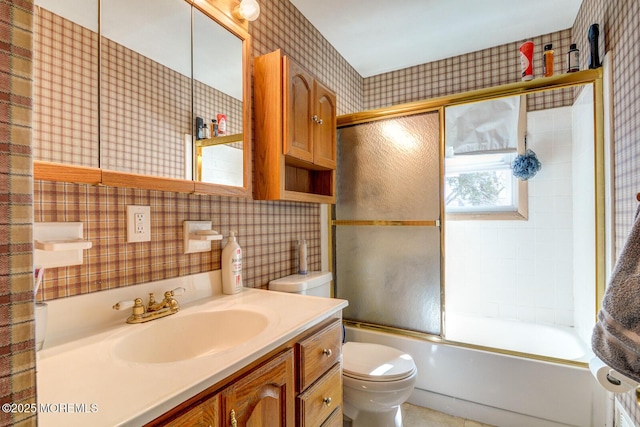 full bathroom featuring shower / bath combination with glass door, vanity, toilet, and wallpapered walls