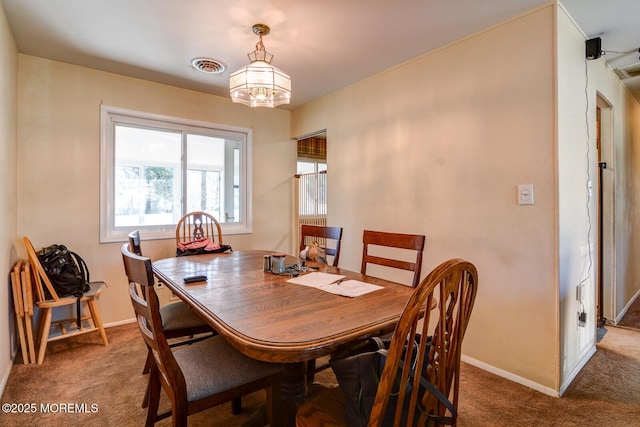 dining area featuring carpet floors, visible vents, and baseboards