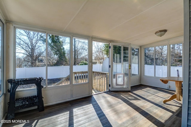 sunroom / solarium featuring vaulted ceiling