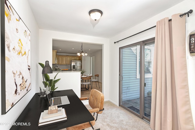 office area featuring baseboards, a chandelier, and light colored carpet