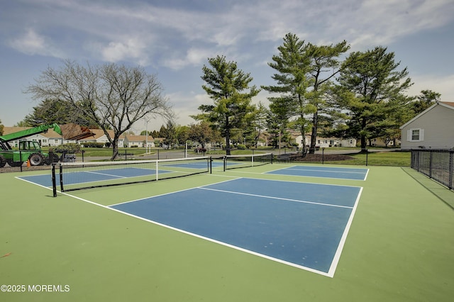 view of tennis court featuring fence