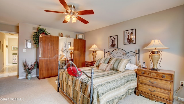 bedroom with baseboards, visible vents, a ceiling fan, and light colored carpet