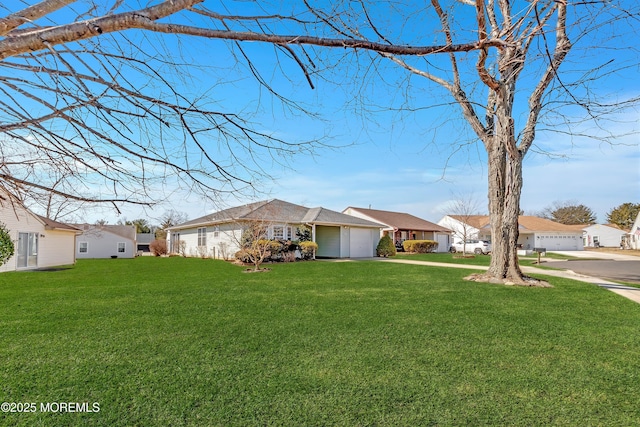 ranch-style house featuring driveway, a front lawn, an attached garage, and a residential view