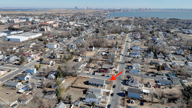 birds eye view of property with a water view and a residential view