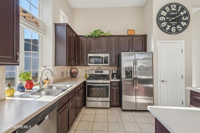 kitchen with appliances with stainless steel finishes, light countertops, and a sink