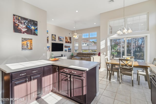 kitchen with pendant lighting, light tile patterned floors, recessed lighting, light countertops, and open floor plan