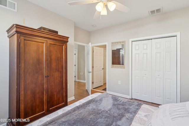 unfurnished bedroom with a ceiling fan, baseboards, visible vents, and a closet