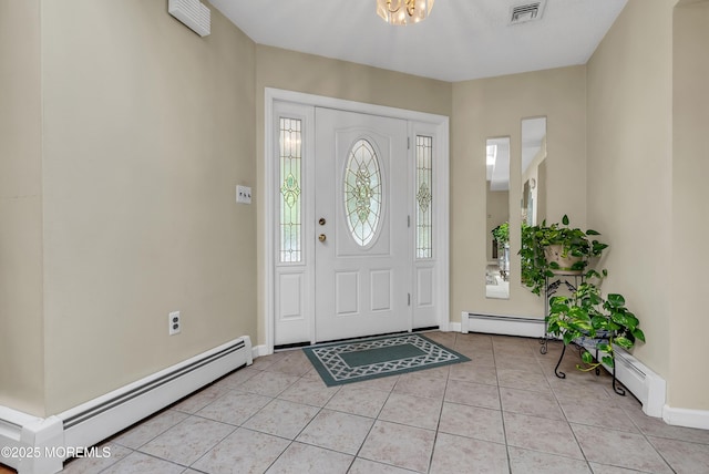 foyer entrance with light tile patterned floors, baseboard heating, visible vents, and baseboards