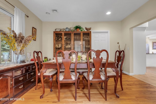 dining room with a wealth of natural light, visible vents, light wood finished floors, and recessed lighting