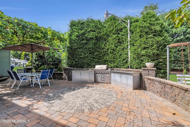 view of patio featuring outdoor dining area, a grill, and an outdoor kitchen