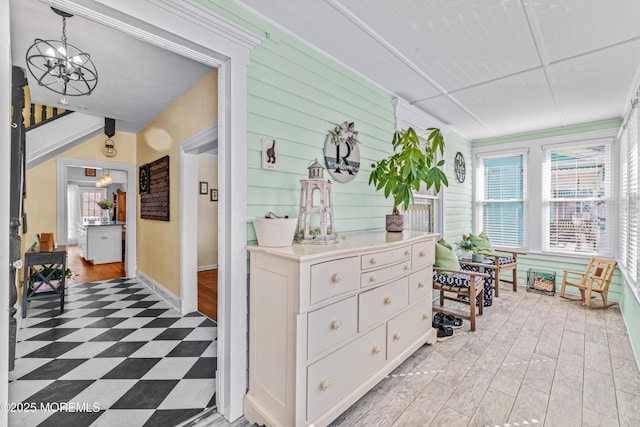 sunroom / solarium featuring a notable chandelier