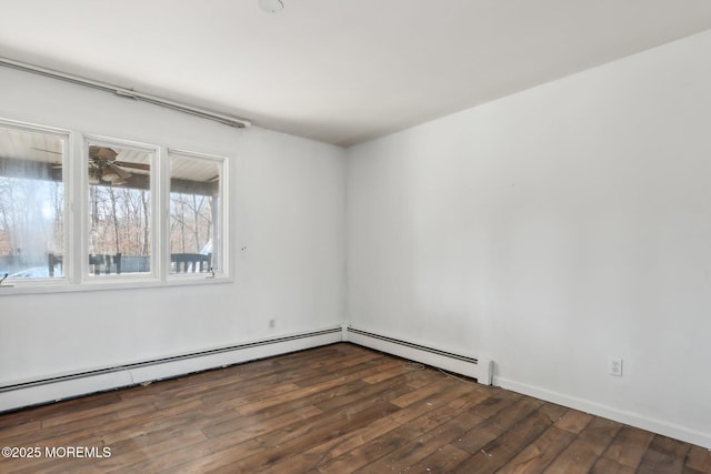 spare room with a baseboard heating unit, ceiling fan, and dark wood finished floors