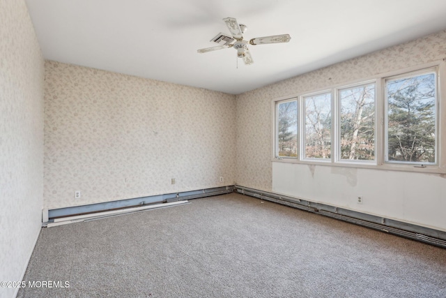 carpeted empty room with wallpapered walls and a ceiling fan