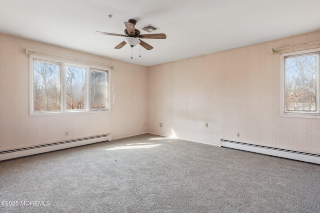 carpeted empty room with visible vents, ceiling fan, baseboard heating, and wallpapered walls