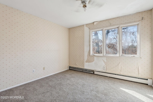 carpeted spare room with a baseboard radiator, baseboards, and wallpapered walls