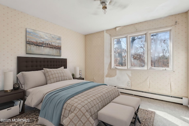 bedroom with a baseboard heating unit, carpet, and wallpapered walls