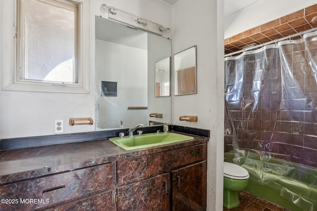 bathroom featuring toilet, shower / bath combination with curtain, and vanity