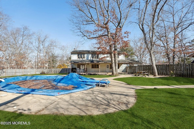 view of pool with a fenced in pool, a patio area, a fenced backyard, and a yard