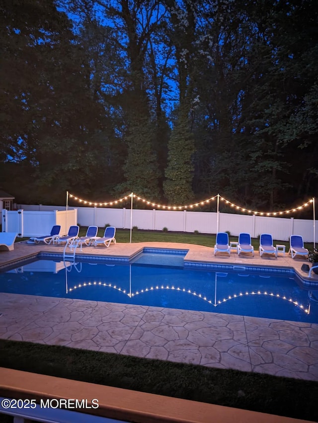 view of swimming pool featuring a fenced in pool, a fenced backyard, and a patio