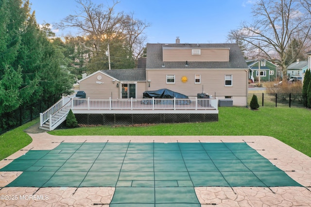 view of pool featuring a deck, a yard, and a patio area