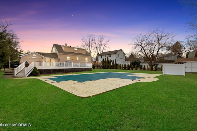 view of pool featuring a fenced in pool, a yard, a patio, fence, and a wooden deck