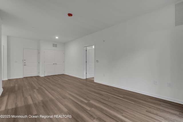 unfurnished room with baseboards, visible vents, and light wood finished floors