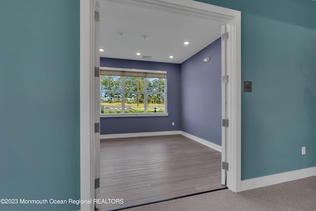 spare room featuring recessed lighting, visible vents, baseboards, and wood finished floors