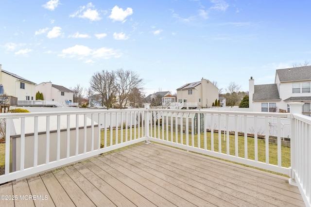 deck featuring a residential view and a yard