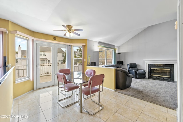 dining area featuring french doors, vaulted ceiling, a wealth of natural light, and light tile patterned flooring