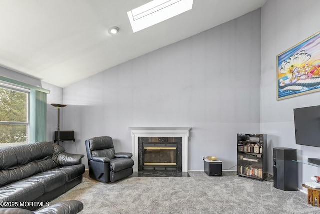 carpeted living area with a skylight, a fireplace, and high vaulted ceiling