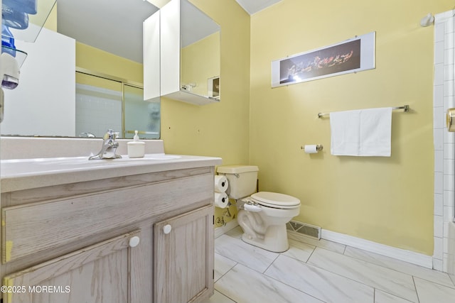 bathroom with a shower with door, visible vents, toilet, vanity, and baseboards