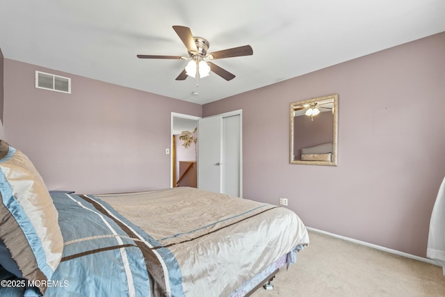 carpeted bedroom featuring ceiling fan, a closet, visible vents, and baseboards