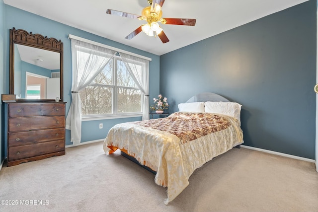 carpeted bedroom featuring a ceiling fan and baseboards