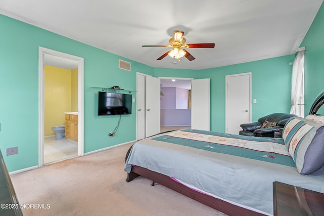 bedroom with baseboards, visible vents, a ceiling fan, ensuite bathroom, and carpet flooring