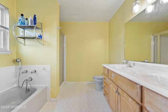 bathroom with a bath, a shower stall, toilet, and a sink