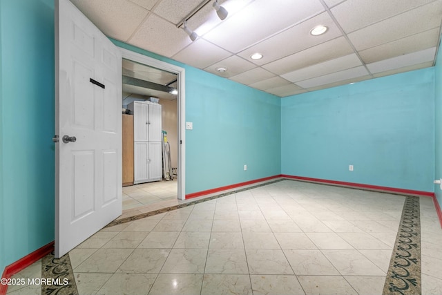 unfurnished room featuring a paneled ceiling, baseboards, and recessed lighting