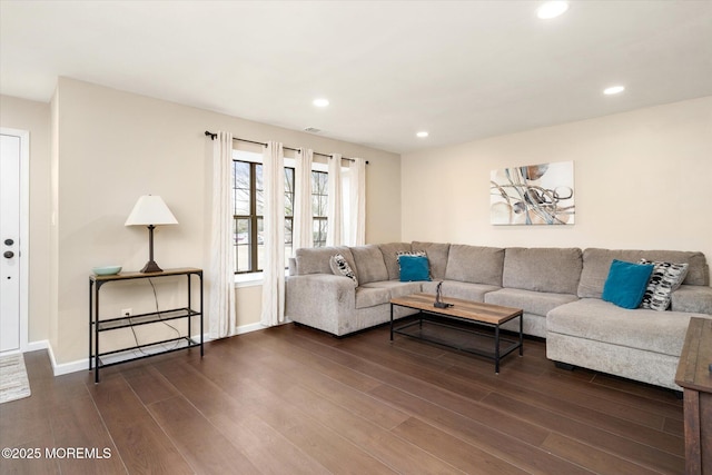 living room with baseboards, dark wood finished floors, and recessed lighting