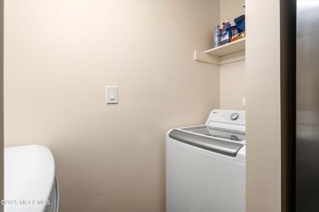 clothes washing area featuring washer / dryer