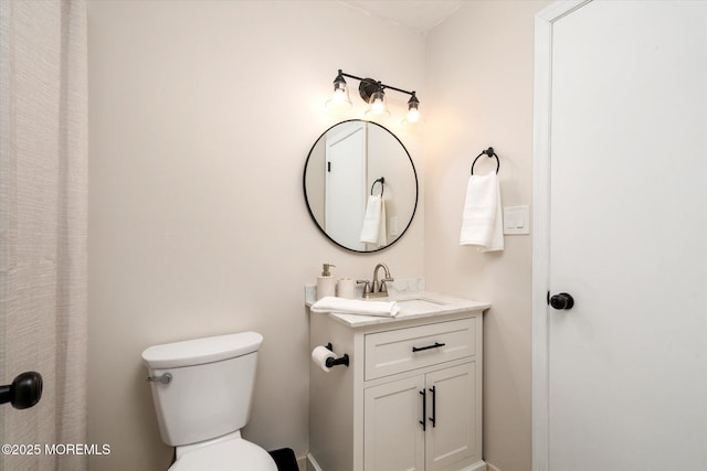 bathroom featuring toilet and vanity