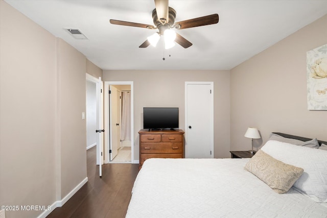 bedroom featuring baseboards, visible vents, dark wood finished floors, and a ceiling fan