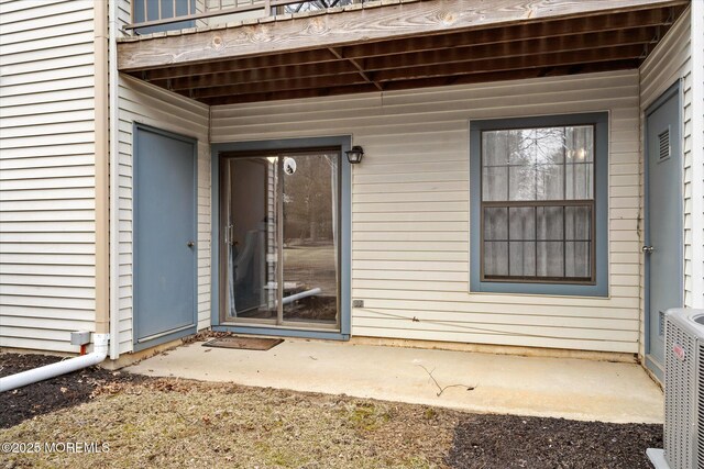 view of exterior entry featuring central AC