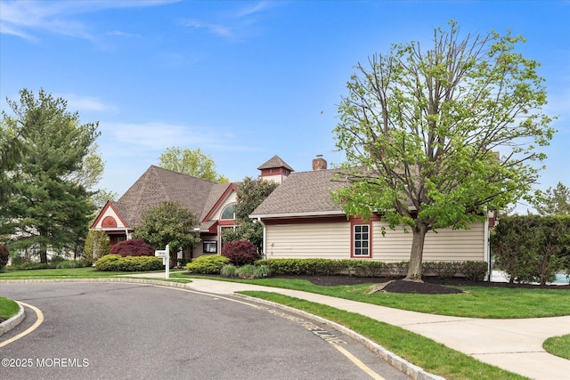 view of front of home with a front yard and a chimney