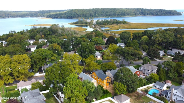 bird's eye view featuring a water view, a forest view, and a residential view