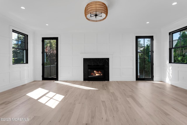121 Black Point Rd, Rumson, NJ 07760 - unfurnished living room featuring a decorative wall, plenty of natural light, wood finished floors, a fireplace, and recessed lighting