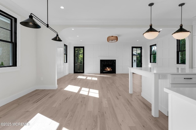 121 Black Point Rd, Rumson, NJ 07760 - unfurnished living room with plenty of natural light, light wood-style floors, a fireplace, recessed lighting, and crown molding