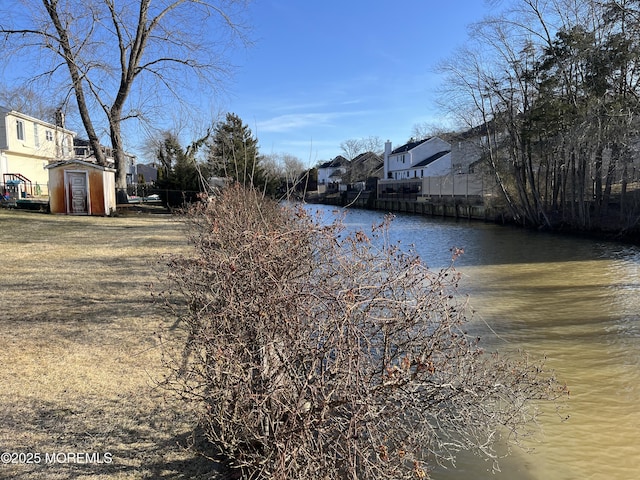 view of road with a residential view and a water view