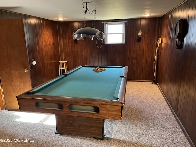 recreation room with pool table, light carpet, and wood walls